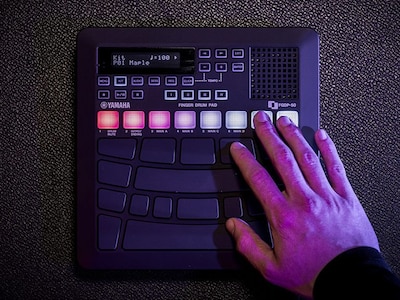 A hand touching the glowing RGD pads of the FGDP-50.