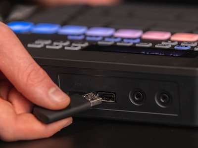 Close-up of the hand inserting USB flash memory into USB TO DEVICE terminal