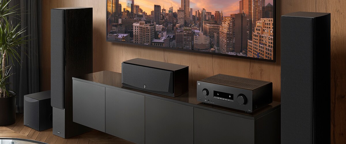 The RX500A, a center speaker, front speakers and a subwoofer in a room.